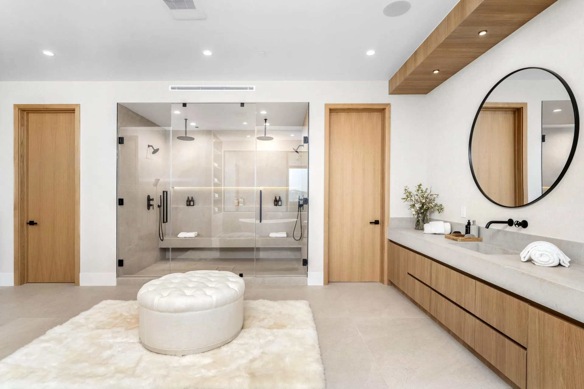 Master bathroom remodel by Mayer's Construction — dual shower and floating vanity